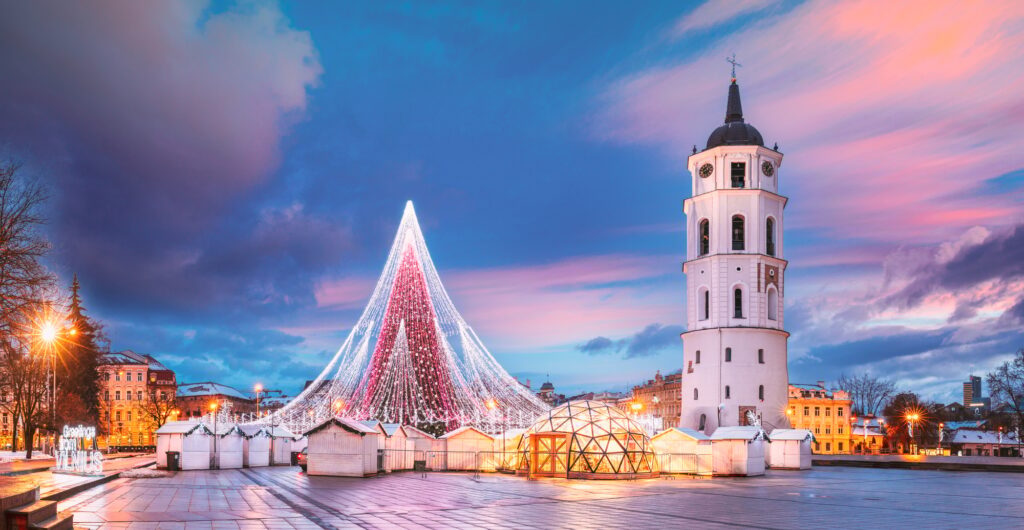 Vilnius, Lithuania. Christmas Tree On Background Bell Tower Belfry Of Vilnius Cathedral At Cathedral